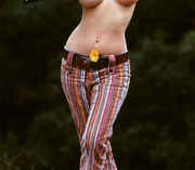 Topless_hippie_with_flower_in_belt.jpg