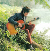 Donovan_playing_guitar_at_lake.jpg