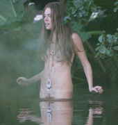 Topless_hippie_girl_eases_into_water.jpg