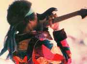 Jimi_playing_guitar_with_teeth.jpg